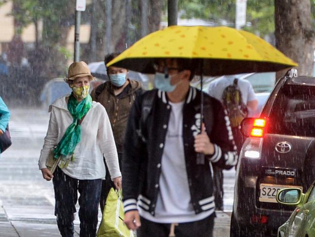 ADELAIDE, AUSTRALIA - NewsWire Photos OCTOBER 28, 2021: People scurry in the rain as storms lash Adelaide. Picture: NCA NewsWire/Brenton Edwards