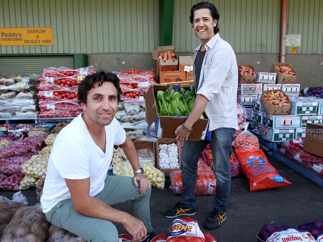 21/04/2017: (L) John De Giusti is a disability support worker and runs a micro-business with people who have intellectual disabilities, as well as taking people on weekend camps, and going on holidays to Fiji to look after disabled children and give their parents a break. He's part of a growing number of men working in disability as the NDIS ramps up, where there is also a need for more male support workers. Photographed with Leonardo Camacho (R), support worker and NDIS provider,  at Paddy's Markets, where they do fruit deliveries. Hollie Adams/The Australian