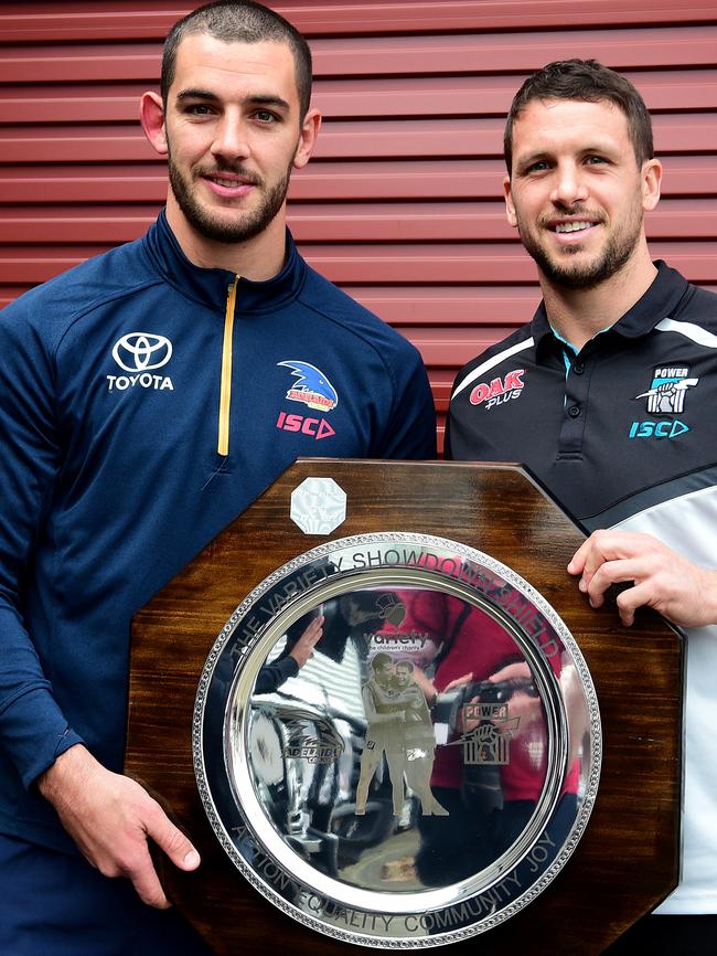 Crows captain Taylor Walker and Port Adelaide captain Travis Boak hold the Variety Showdown Shield on Wednesday ahead of Saturday’s clash at Adelaide Oval. Picture: Bianca De Marchi