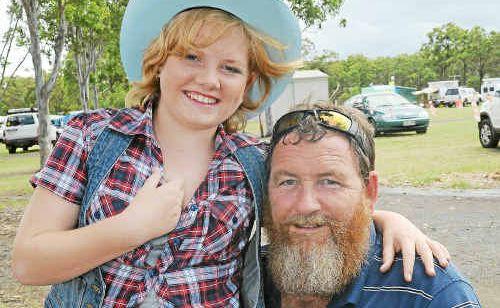 Sophie and dad Paul Raymond enjoy the country music at the Bundy Easter Round-up.