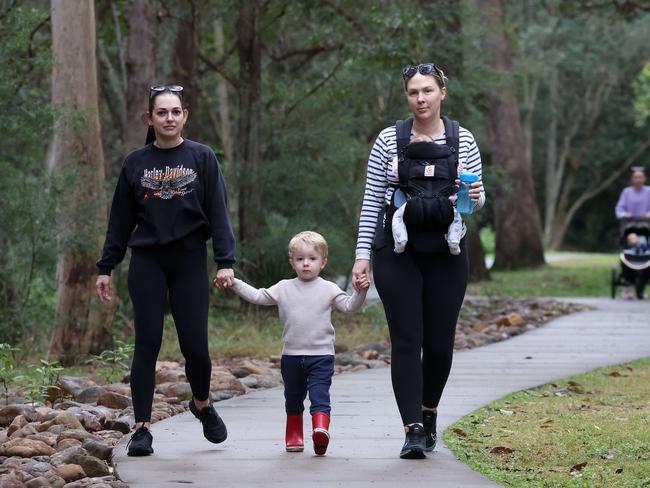 Francoise Le-gall, Beau Seymour, 3, Elena Seymour and Sienna Seymour, 4 months old, take a stroll at Mt Coot-tha. Ms Seymour said she would still wouldn’t walk in the area alone, despite the new cameras. Picture: Liam Kidston