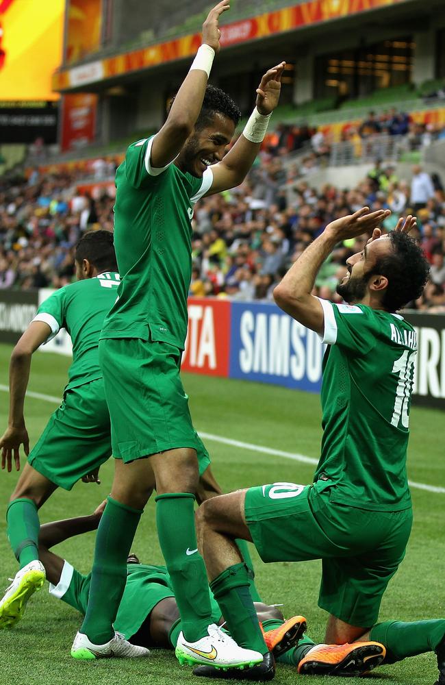 The Saudi players congratulate each other after another goal.