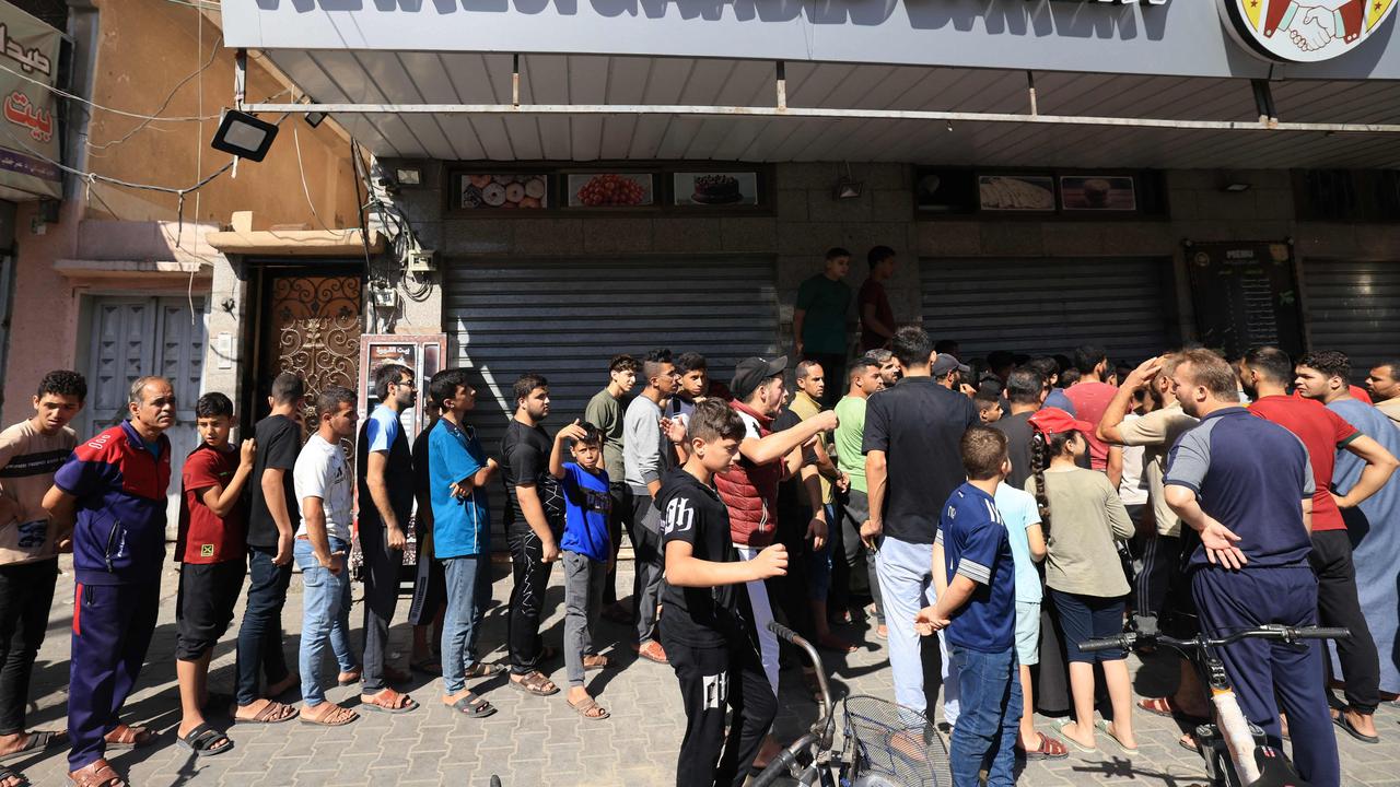 Displaced Palestinians queue for bread amid Israeli strikes in Khan Yunis, in the southern Gaza Strip on October 15. Picture: Mahmud Hams / AFP