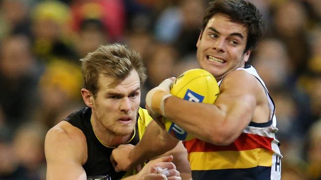 AFL Round 16. 06/07/2018. Richmond v Adelaide at the MCG.  Adelaide's Darcy Fogarty tries to break the tackle of Richmond's David Astbury  . Pic: Michael Klein