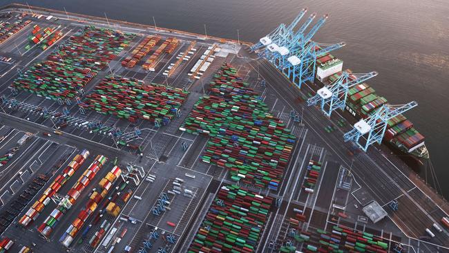 Shipping containers and a container ship at the Port of Los Angeles last month. Around the world transport is failing, costs are soaring and ports shut down overnight from outbreaks or power cuts. Picture: AFP