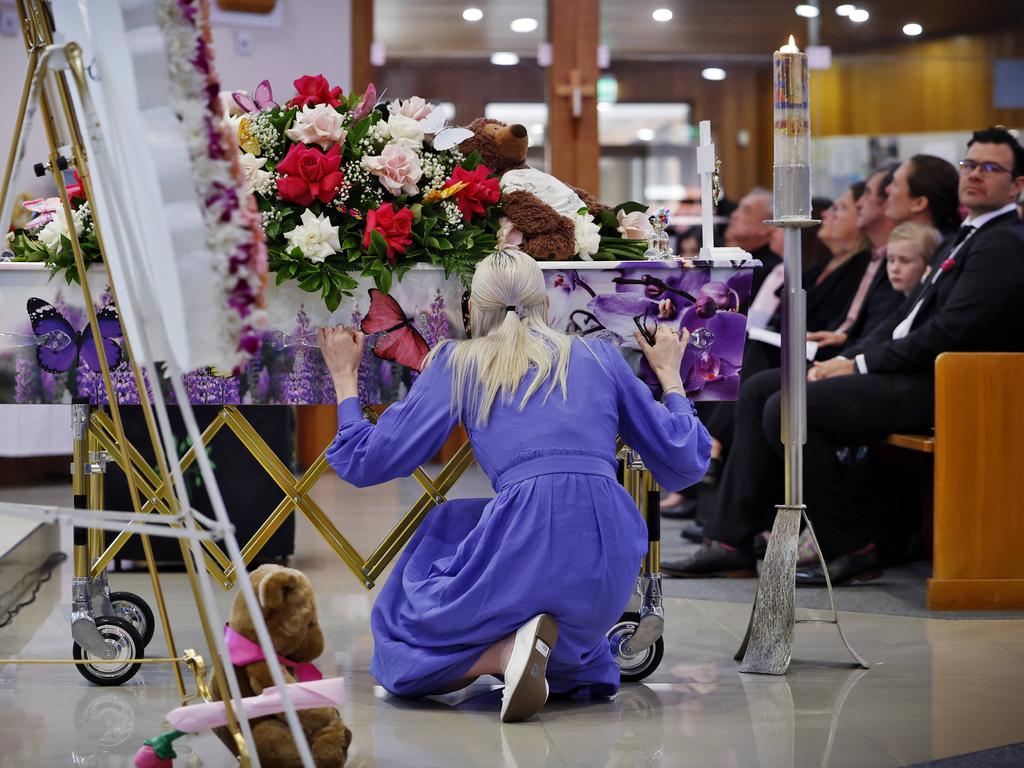 Charlotte’s mum crouches next to the casket as the funeral begins to end. Picture: Sam Ruttyn