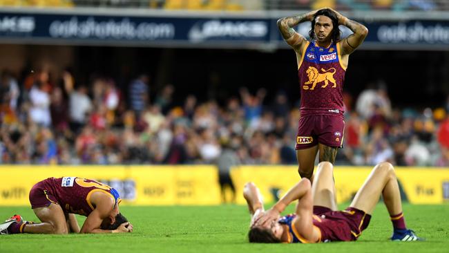 Lions players slump to the ground after Cameron Rayner’s missed shot and the final siren.