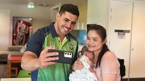 Raiders halfback Jamal Fogarty does a selfie with local mum Mu Dah and her baby at Ronald McDonald House in Canberra. Picture: Supplied