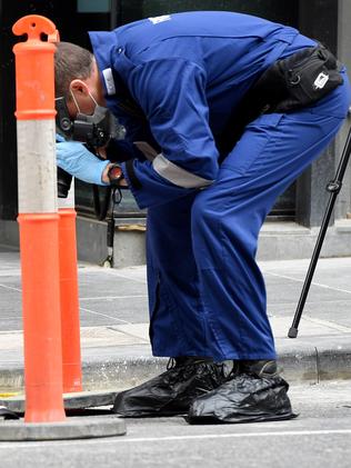 Forensic investigators search for evidence outside the EQ Tower. Picture: Nicole Garmston