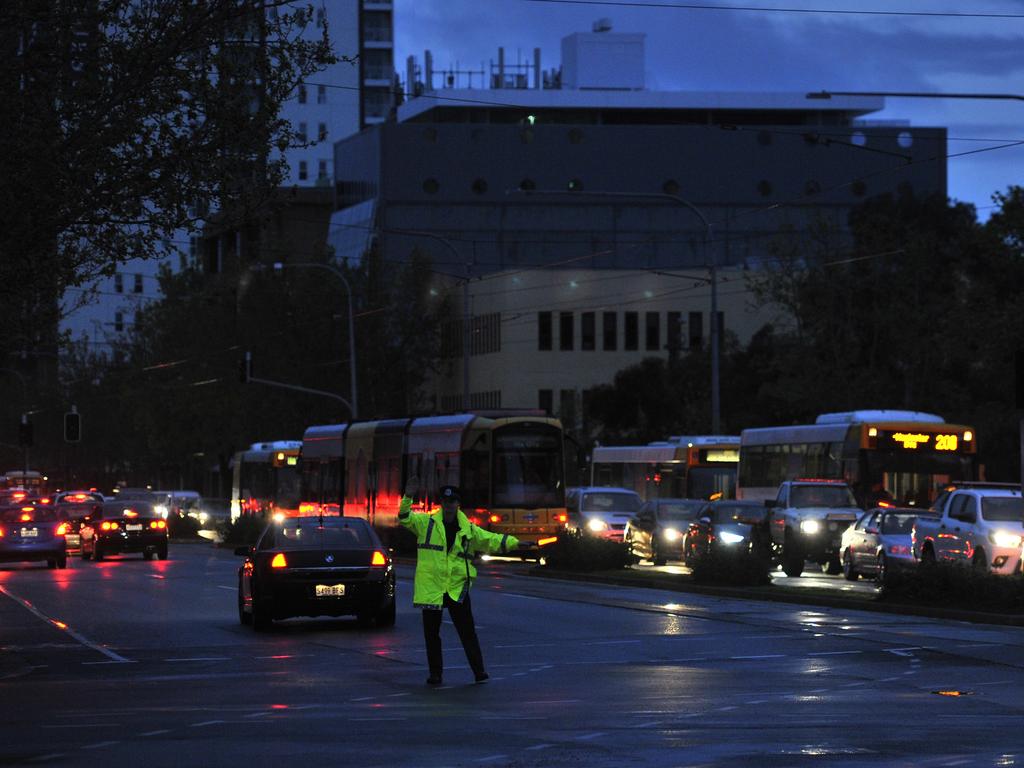 Police direct traffic around the Adelaide CBD after a statewide blackout in September 2016. The event prompted a lot of queries about solar power. Picture: AAP Image/David Mariuz