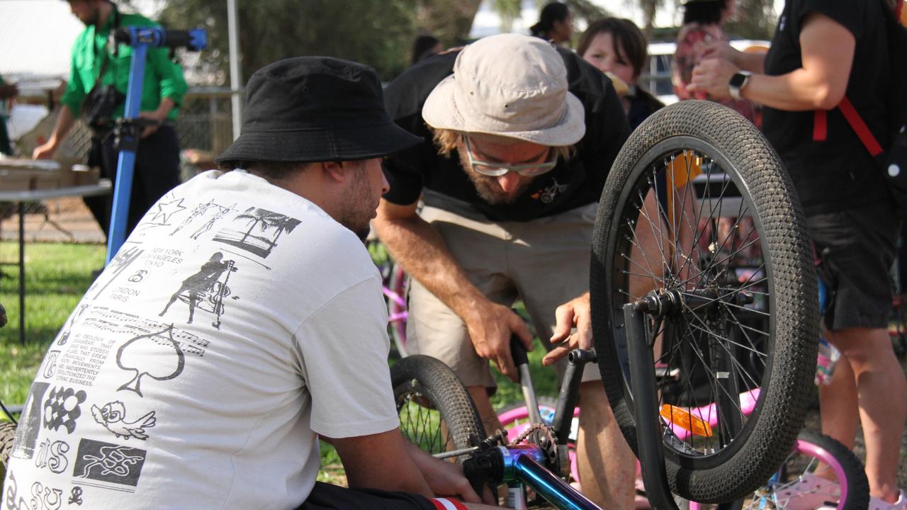 Bikes Mwerre volunteers get a push-bike up and running in Lyndavale Park in Larapinta, Alice Springs, October 16, 2024. Picture: Gera Kazakov