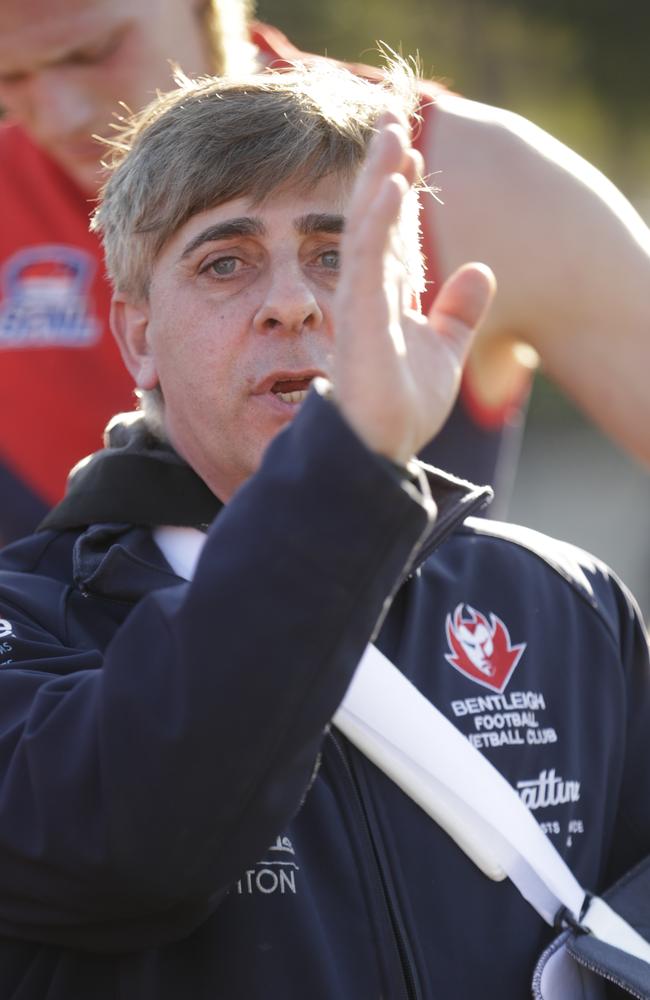 An injured Peter Pirera urges on his troops at the last change; whatever he said worked for the doughty Demons.