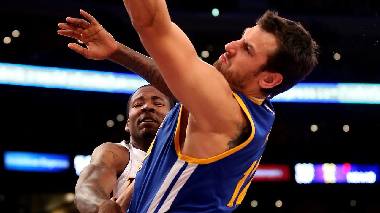 LOS ANGELES, CA - NOVEMBER 16: Andrew Bogut #12 of the Golden State Warriors shoots over Ed Davis #21 of the Los Angeles Lakers at Staples Center on November 16, 2014 in Los Angeles, California. NOTE TO USER: User expressly acknowledges and agrees that, by downloading and or using this photograph, User is consenting to the terms and conditions of the Getty Images License Agreement. Stephen Dunn/Getty Images/AFP == FOR NEWSPAPERS, INTERNET, TELCOS & TELEVISION USE ONLY ==