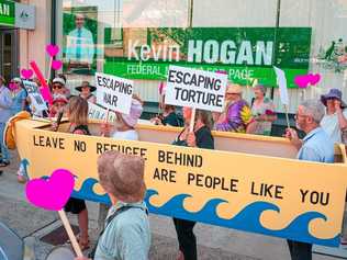 Lismore City Councillor Eddie Lloyd (with microphone) joins refugee advocates and other members of Council in a vigil outside MP Kevin Hogan's office. Picture: Courtesy of R Poole