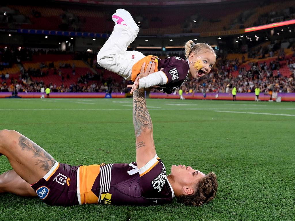 Reece Walsh of the Broncos celebrates a win with his daughter Leila. Picture: Getty Images