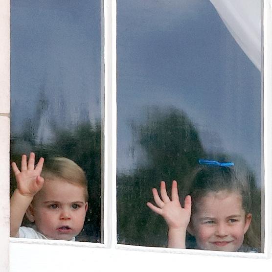 Prince Louis and Princess Charlotte wave from a window of Buckingham Palace as they attend Trooping The Colour. Picture: Max Mumby/Indigo/Getty Images