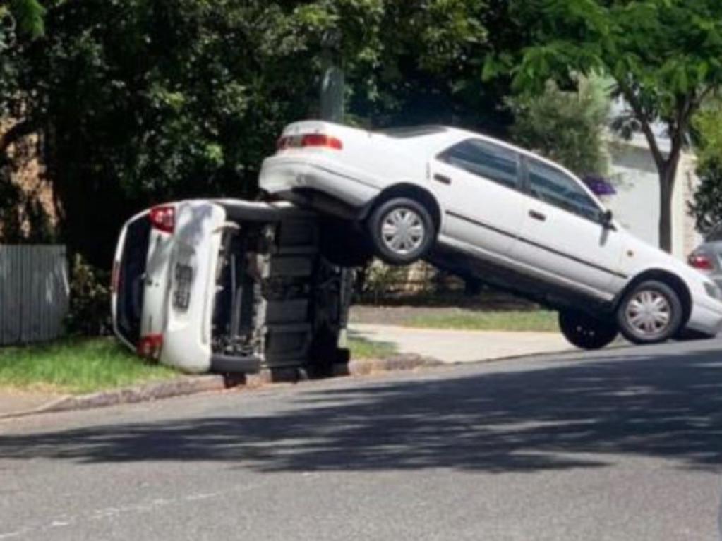 A car being driven by an elderly man mounted another car in a Brisbane suburb.