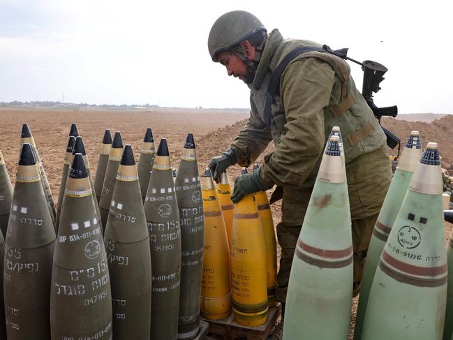 An Israeli soldier arranges artillery shells on the border with Gaza in southern Israel. Picture: Jack Guez/AFP