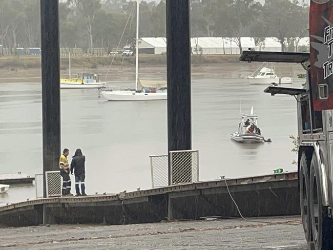 The stolen $350,000 Ford F350 dumped in crocodile-infested waters of the Fitzroy River from the Quay Street, Rockhampton, boat ramp, was located by divers metres down stream. Pictured are the water police with a diver at the location the ute was found before the salvage operation on July 4.