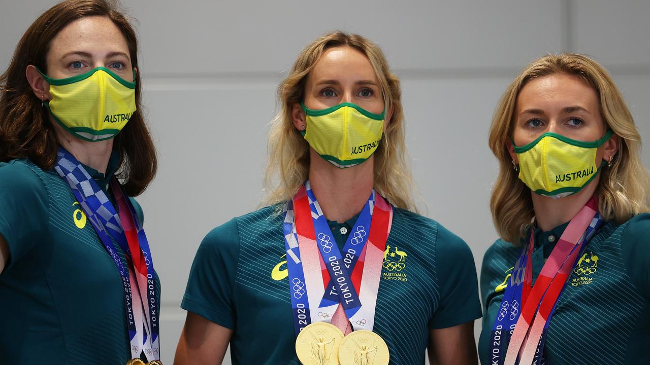 Cate Campbell, Emma McKeon and Ariarne Titmus pose with their medals.