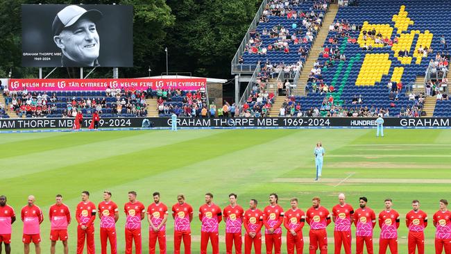 Match officials and players in The Hundred competition observe a minute's silence in tribute to Graham Thorpe in Cardiff, Wales. (Photo by Dan Istitene/Getty Images)