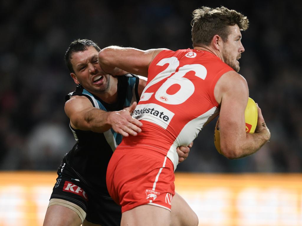 Luke Parker tackled by Travis Boak on Saturday night. Picture: Mark Brake/Getty Images.