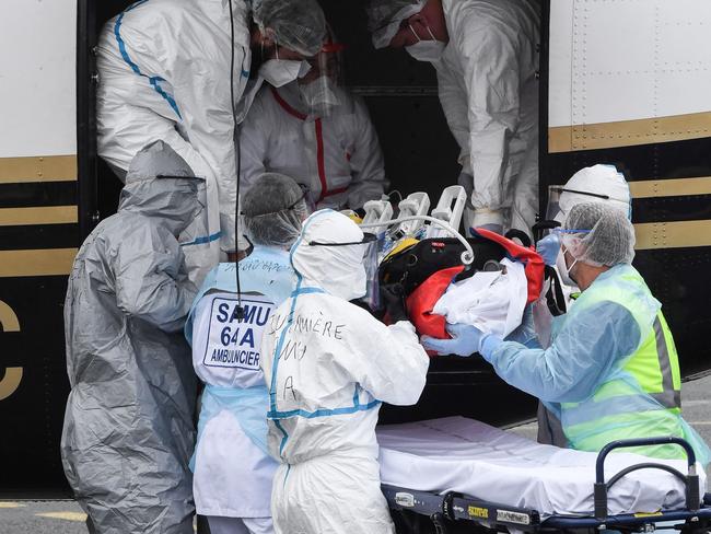 Medical staff lowers one of two Covid-19 patients transported by Emergency Medical Service from the Ile-de-France area to Biarritz as hospitals struggle to keep up with a surge in cases. Picture: AFP