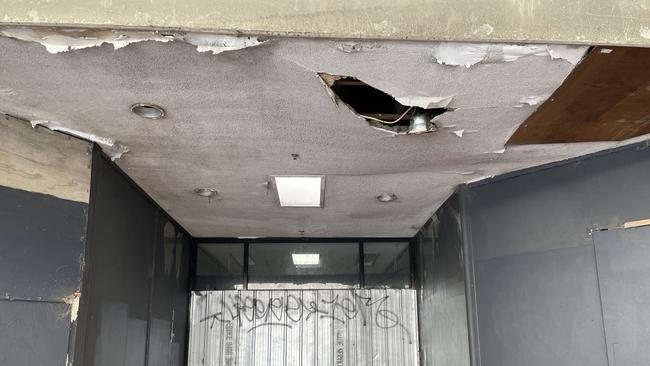 A Frankston mall that runs between Nepean Highway and Keys Street has been shuttered for years and is now falling with large holes and pieces of building materials in danger of landing on pedestrians below. Picture: Lucy Callander