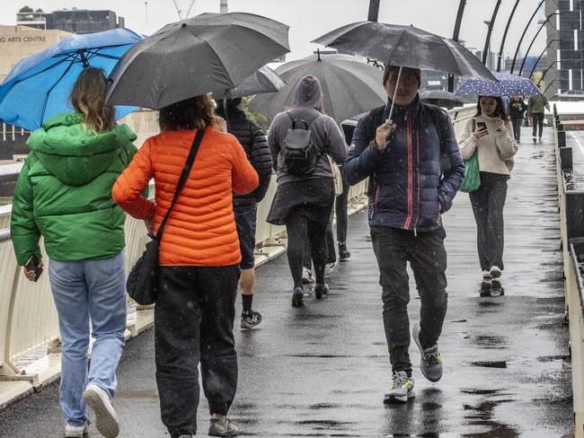 BRISBANE AUSTRALIA - NewsWire NCA Photos JULY 5, 2022: Queenslanders rug up as heavy rain and colder than average temperatures hit Brisbane today. NewsWire / Sarah Marshall