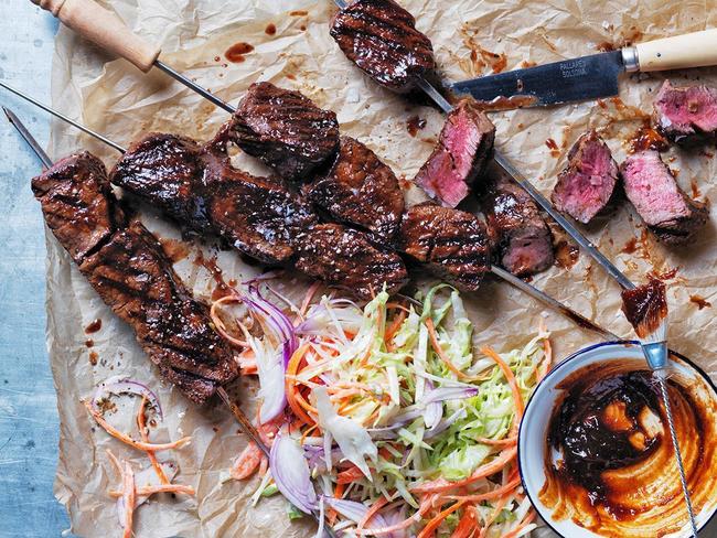 Barbecued glazed beef skewers with iceberg slaw.