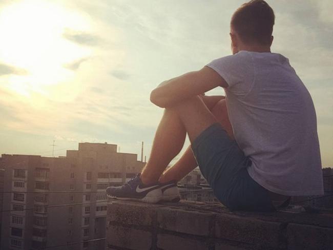 Living on the edge ... Andrey Retrovesky sitting on the edge of a building. Picture: Instagram