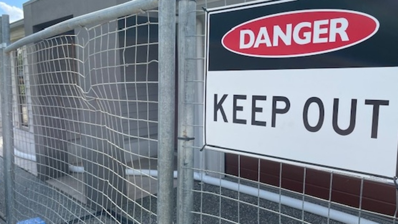 Fencing and signage at a Riverstone Crossing home on the Gold Coast evacuated after a landslip.
