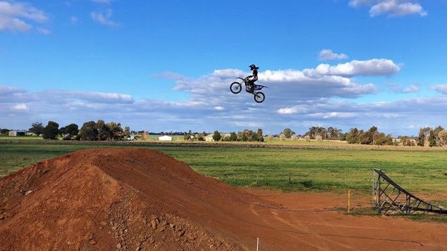 Christina making a jump on her motocross bike.