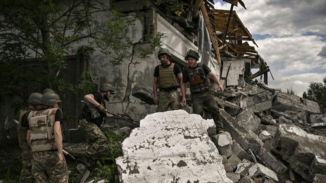 Ukrainian soldiers inspect a destroyed warehouse reportedly targeted by Russian troops on outskirts of Lysychansk. Picture: ARIS MESSINIS / AFP