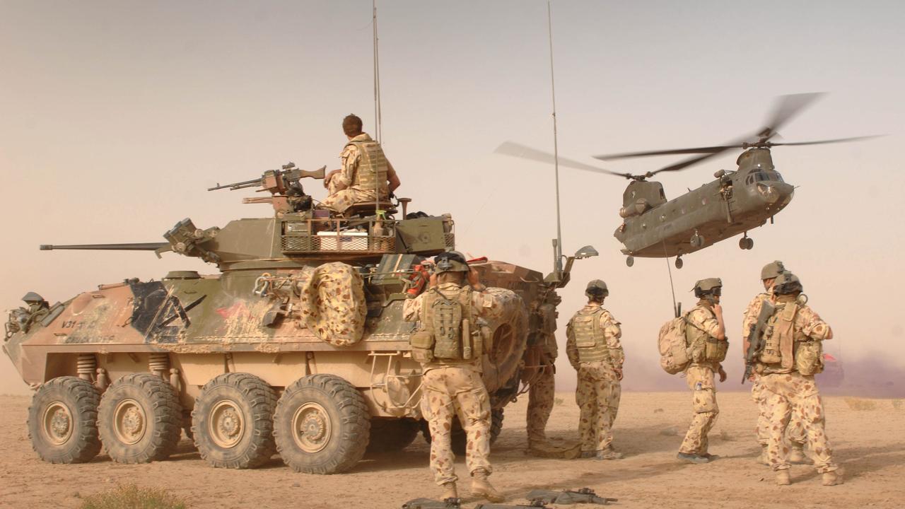 SAS soldiers look on as a helicopter arrives with vital supplies in Afghanistan. Picture: Supplied