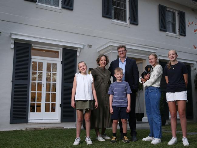 31/05/2024. Claire and Alex Rhydderch, photographed at home with their kids Mavis, 14, Agnes, 12, Myrtle, 10, Doug, 8, and their sausage dog Wilma. The couple always thought they would sell their home in Sydney's Roseville in the springtime when their manicured gardens were blooming. Instead, the trees will be bare when they head to auction mid-June. The property market is unusually busy leading into winter, typically the quietest period of the year. Britta Campion / The Australian
