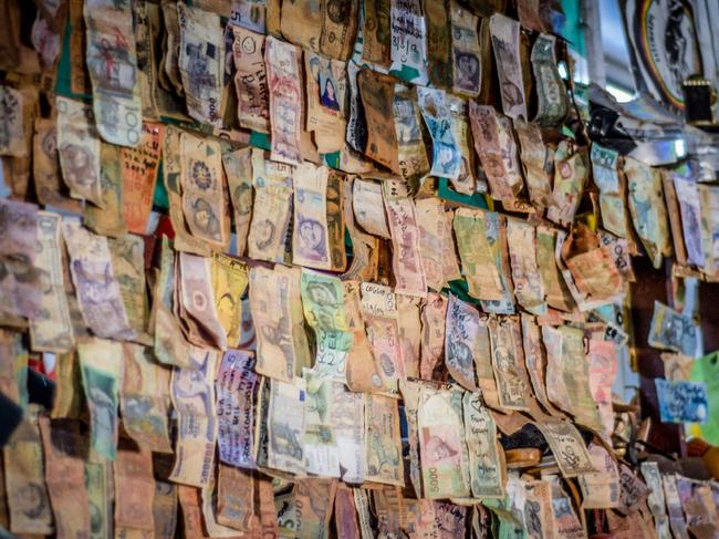 Currency from around the world adorn the walls of The Daly Waters Outback Pub.