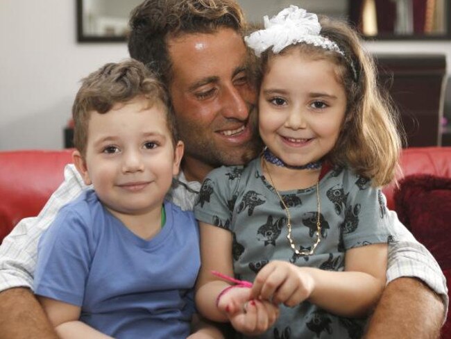 The two children who were abducted in the street by CARI are pictured with their father.