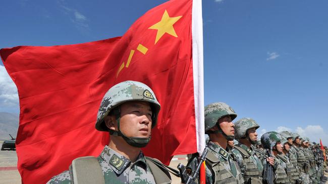 A Chinese soldier holds a Chinese flag during Peace Mission-2016 joint military exercises of the Shanghai Cooperation Organisation (SCO) in the Edelweiss training area in Balykchy, some 200 km from Bishkek.