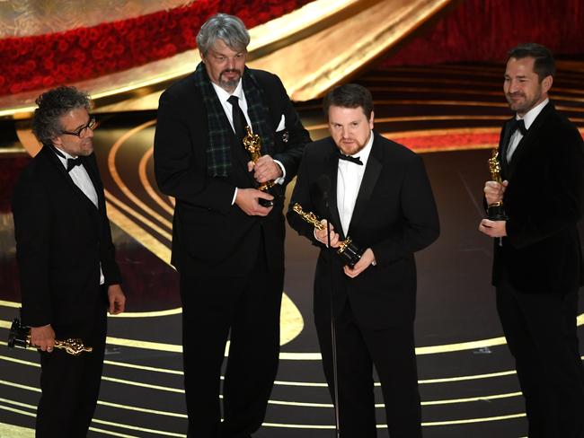 Paul Lambert, Ian Hunter, J. D. Schwalm and Tristan Myles accept the Best Visual Effects award for "First Man". Picture: Getty