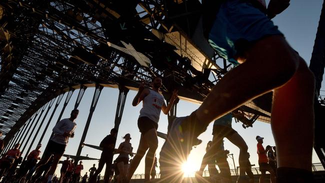 Participants running across the Sydney Harbour Bridge on Sunday.