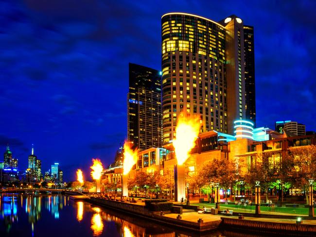 Melbourne, Australia, in early evening light. Yarra River, towards Flinders Street Station Crown Casino Fire