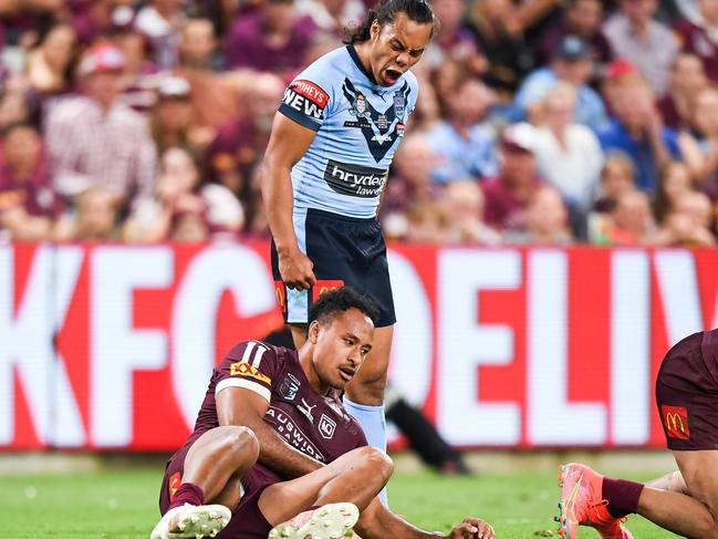 Blues five-eighth Jarome Luai stands over Maroons forward Felise Kaufusi