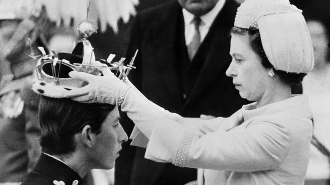 Queen Elizabeth II puts a crown on her son, Prince Charles, during his investiture as Prince of Wales in Caernarfon. Picture: Central Press/AFP