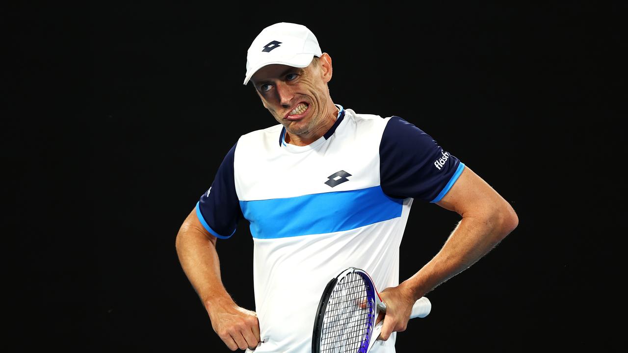 John Millman shows emotion during Friday night’s loss to Roger Federer.