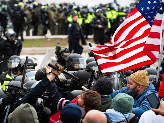 ‘Fear of political violence’ ... supporters of Donald Trump fight with riot police outside the Capitol in Washington on January 6, 2021, protesting against Joe Biden's election win over then-President Trump.