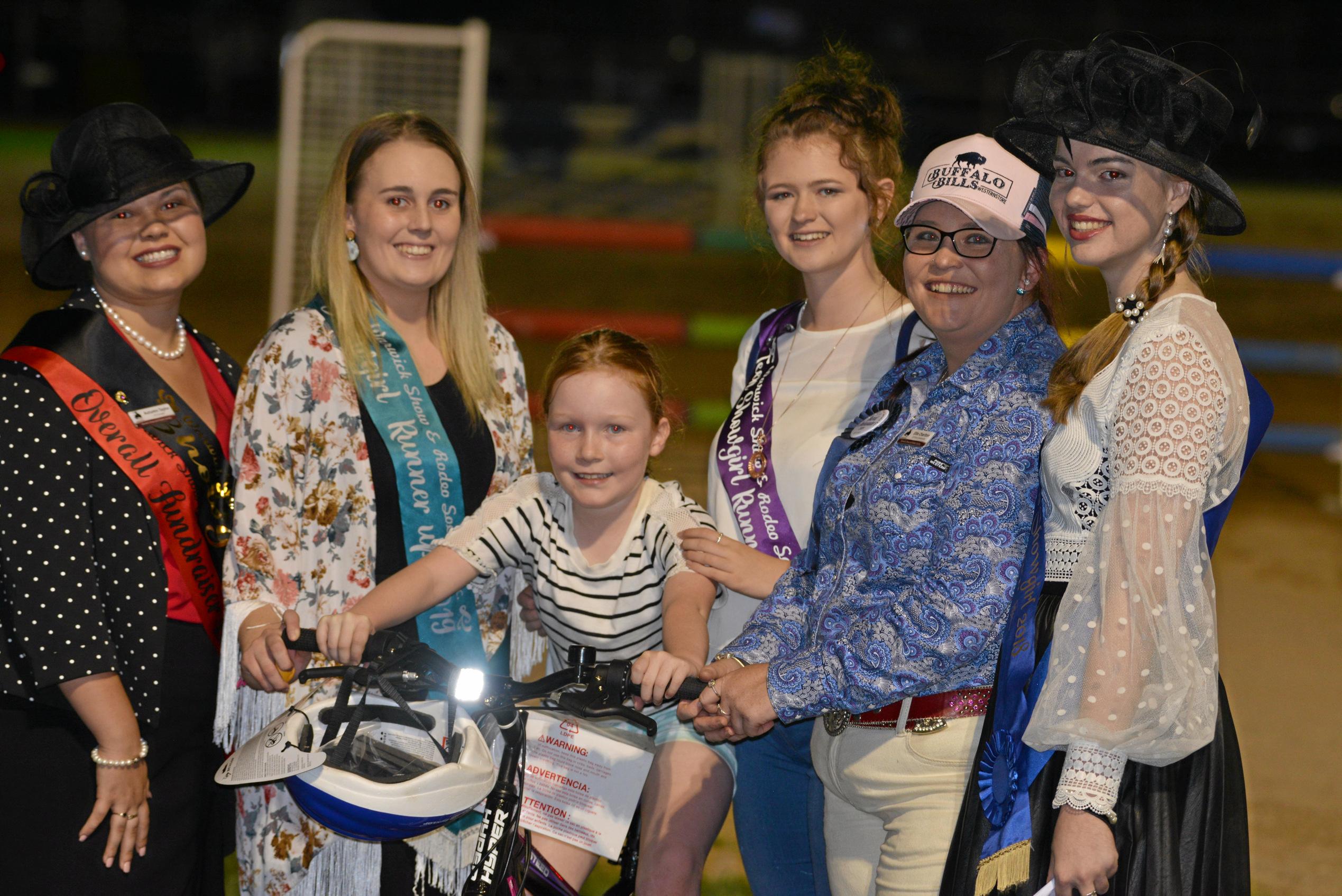 Rodeo queens and showgirls with Lizzie Gillespie who won a bike from Carey Brothers at the Warwick Show. Picture: Gerard Walsh