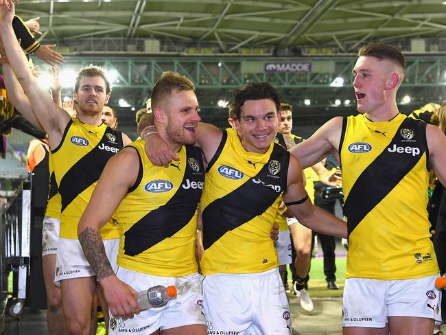 Brandon Ellis, Daniel Rioli and Callum Moore of the Tigers celebrate