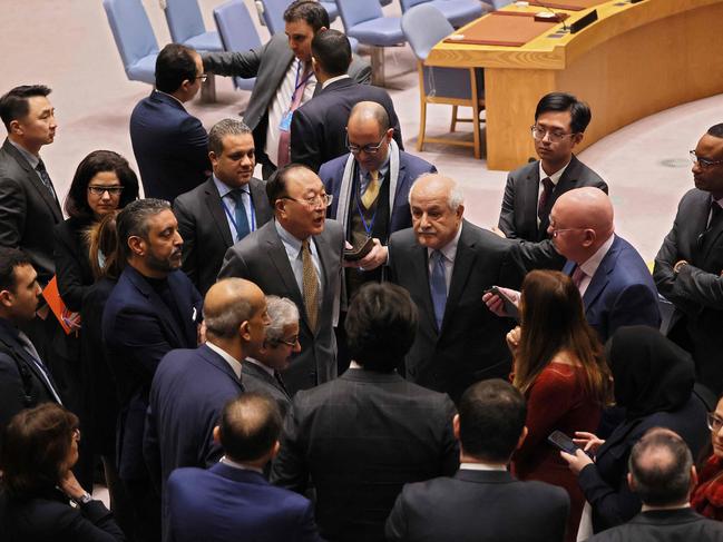 Palestinian Ambassador to the United Nations Riyad Mansour (fourth from right) speaks to members of the UN Security Council as they break during a meeting on the Israel-Hamas war. Picture: Getty Images via AFP