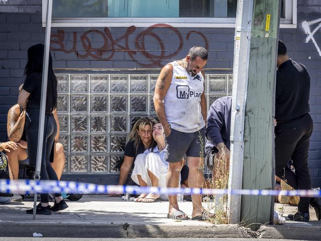 Mourners at the scene of the shooting. Picture: Jake Nowakowski